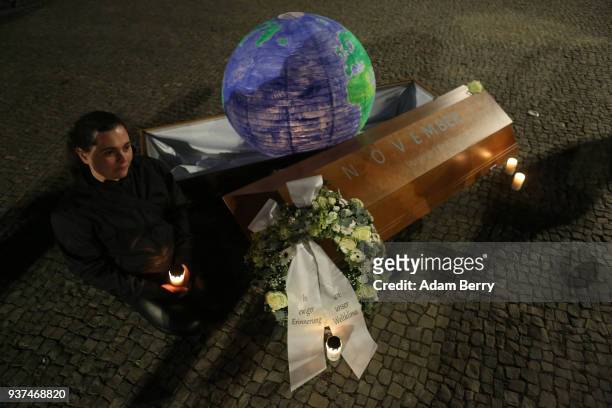 Coffin with a model of the Planet Earth inside is seen in front of the Brandenburg Gate during Earth Hour 2018 on March 24, 2018 in Berlin, Germany....