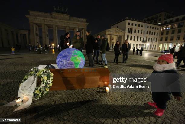 Coffin with a model of the Planet Earth inside is seen in front of the Brandenburg Gate during Earth Hour 2018 on March 24, 2018 in Berlin, Germany....