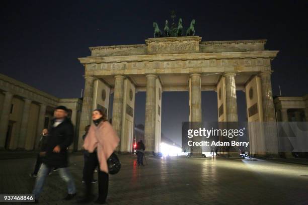 The Brandenburg Gate is seen just after being unilluminated during Earth Hour 2018 on March 24, 2018 in Berlin, Germany. According to organizers,...