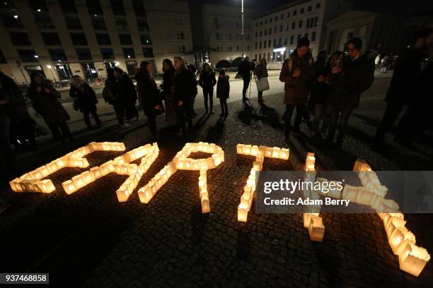 Participants attend Earth Hour 2018 in front of the Brandenburg Gate on March 24, 2018 in Berlin, Germany. According to organizers, Earth Hour has...