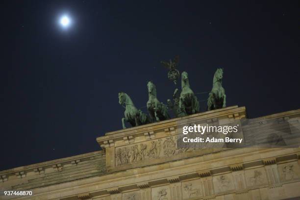 The Brandenburg Gate is seen just after being unilluminated during Earth Hour 2018 on March 24, 2018 in Berlin, Germany. According to organizers,...