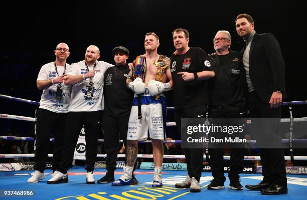 Callum Johnson celebrates victory over Frank Buglioni with trainer Joe Gallagher, promoter Eddie Hearn and his team after British and Commonwealth...