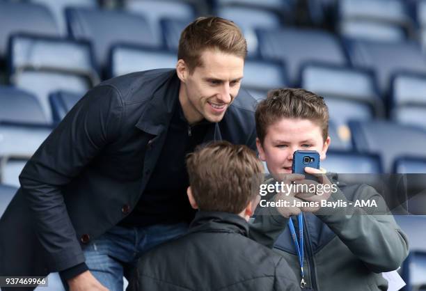 David Edwards of Reading has a selfie with two young Shrewsbury Town supporters during the Sky Bet League One match between Shrewsbury Town and AFC...