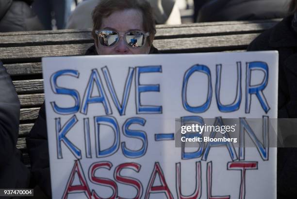 Demonstrators holds a sign that reads "Save Our Kids-Ban Assault," on Pennsylvania Avenue during the March For Our Lives in Washington, D.C., U.S.,...