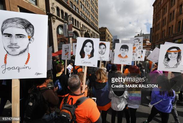 Students hold portraits of victims of Florida's Marjory Stoneman Douglas High School shootings, as they protest for tighter gun laws during the...