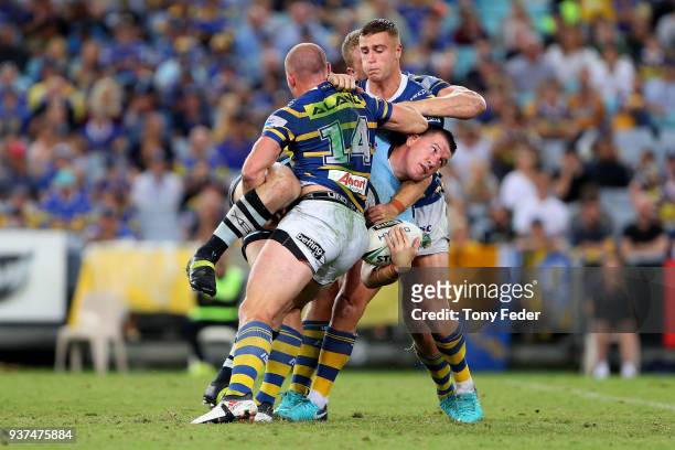 Paul Gallen of the Sharks is tackled during the round three NRL match between the Parramatta Eels and the Cronulla Sharks at ANZ Stadium on March 24,...