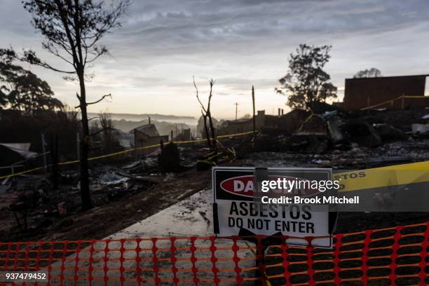 Houses destroyed by bushfire are seen at dawn on March 25, 2018 in Tathra, Australia. A bushfire which started on 18 March destroyed 65 houses, 35...