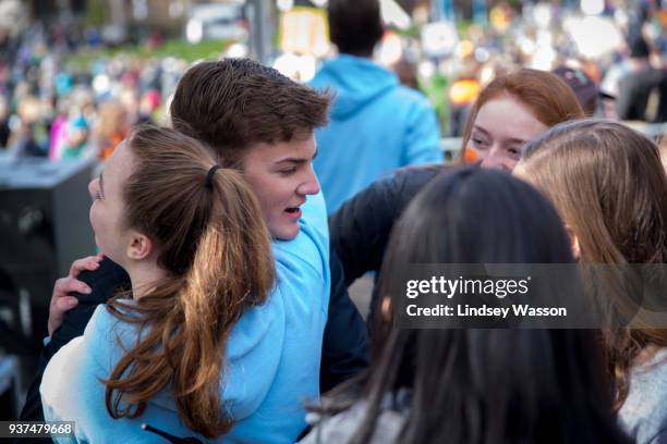 Student organizers Emilia Allard and Alex Davidson hug after the March for Our Lives rally on March 24, 2018 at Seattle Center in Seattle,...