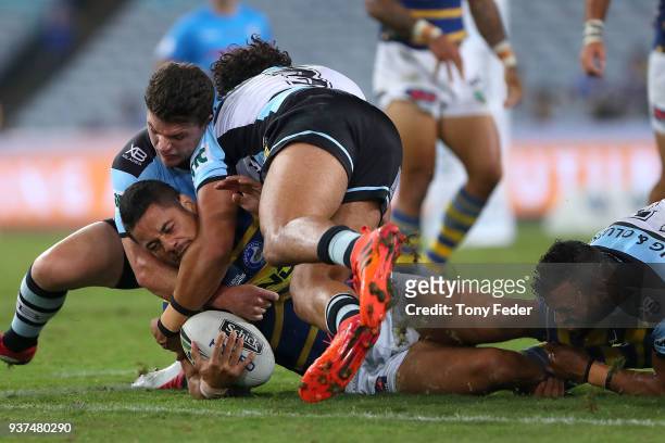 Jarryd Hayne of the Eels is tackled during the round three NRL match between the Parramatta Eels and the Cronulla Sharks at ANZ Stadium on March 24,...