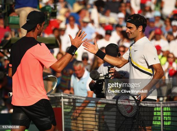 Thanasi Kokkinakis of Australia shakes hands at the net after his three set victory against Roger Federer of Switzerland in their second round match...