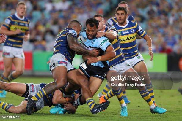 Joseph Paulo of the Sharks is tackled during the round three NRL match between the Parramatta Eels and the Cronulla Sharks at ANZ Stadium on March...