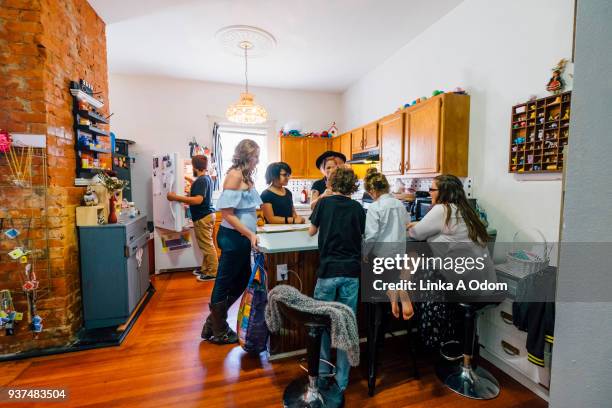 diverse family playing game in kitchen - game night stock-fotos und bilder