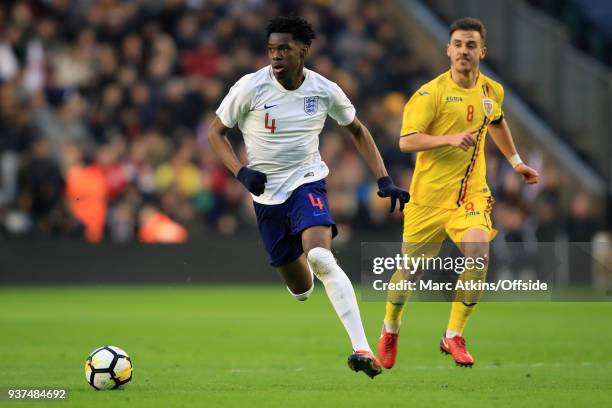 Ovie Ejaria of England in action with Razvan Oaida of Romania during the U21 International Friendly match between England U21 and Romania U21 at...