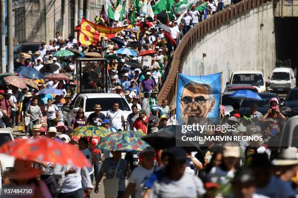 Catholic faithfuls take part in a march commemorating the 38th anniversary of the assassination of Salvadorean Archbishop Oscar Arnulfo Romero in San...