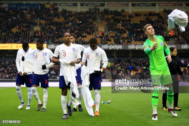 Kyle Walker-Peters and Dean Henderson of England lead their team mates as they discard their tracksuits during the U21 International Friendly match...