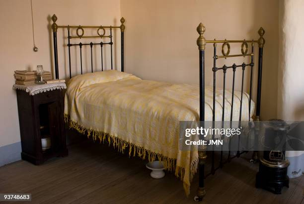House-Museum of the author Antonio Machado, his books, bed, bedside table, wood heater in his bedroom, Segovia , Autonomous Community of Castilla...