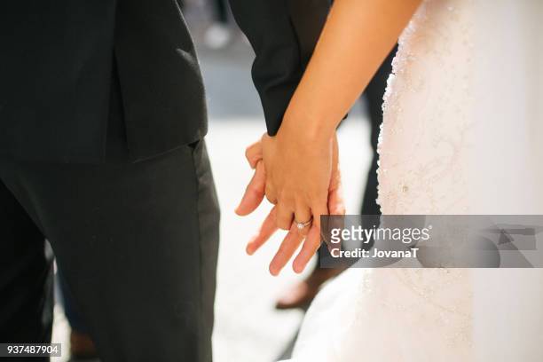 bride and groom holding hands - jovanat stock pictures, royalty-free photos & images