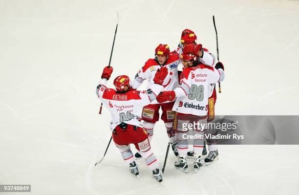 Rainer Koettstorfer of Scorpions is celebrated by his team mates after scoring his team's first goal during the Deutsche Eishockey Liga game between...