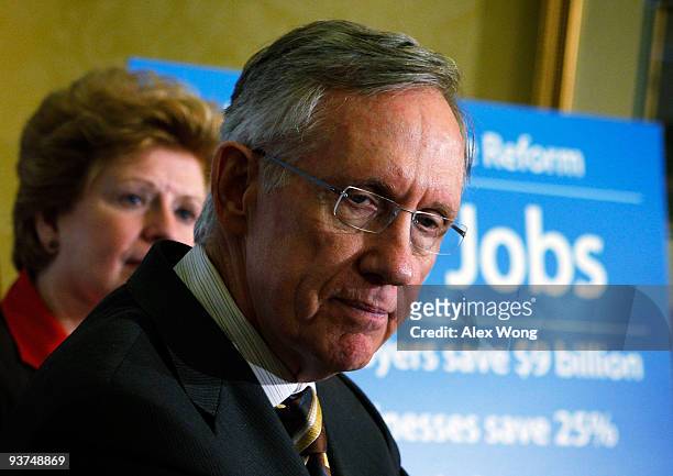 Senate Majority Leader Harry Reid pauses as Sen. Debbie Stabenow listens during a news conference on Capitol Hill December 3, 2009 in Washington, DC....