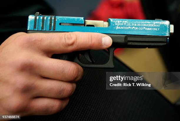 Joe Deedon, former law enforecement officer and owner of Tac*One Consulting holds a Glock pistol converted to fire Simunition as he teaches a "Lone...