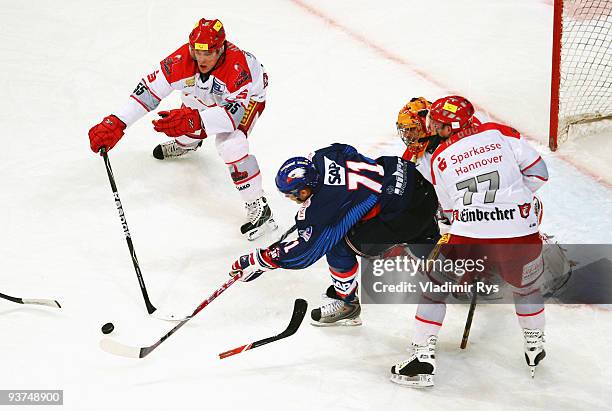 Justin Papineau of Adler battles for the puck with Patrick Koeppchen , Nikolai Goc and goalie Levente Szuper of Scorpions during the Deutsche...