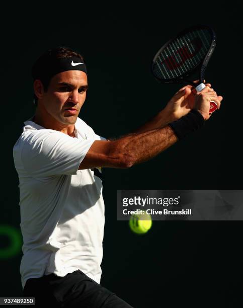 Roger Federer of Switzerland plays a backhand against Thanasi Kokkinakis of Australia in their second round match during the Miami Open Presented by...