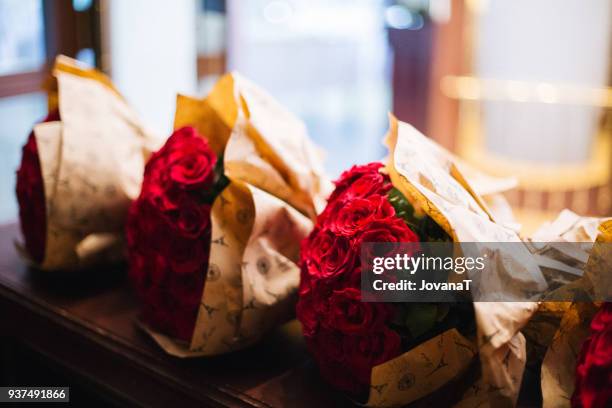 three lovely red roses bouquets on table - jovanat stock pictures, royalty-free photos & images