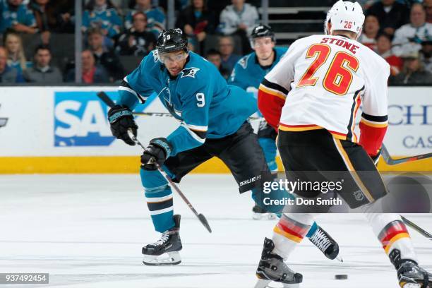 Michael Stone of the Calgary Flames defends Evander Kane of the San Jose Sharks at SAP Center on March 24, 2018 in San Jose, California.