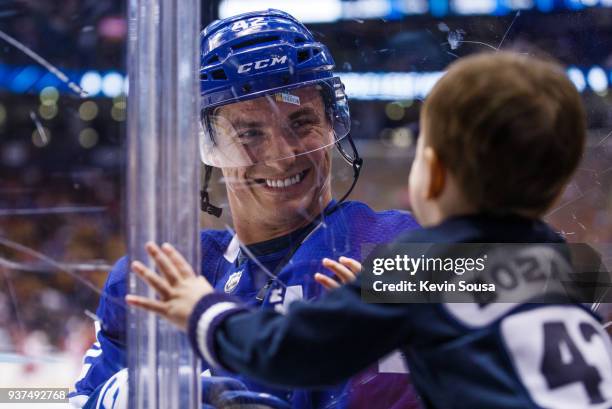 Tyler Bozak of the Toronto Maple Leafs greets his son during warmup before the Leafs face the Detroit Red Wings at the Air Canada Centre on March 24,...