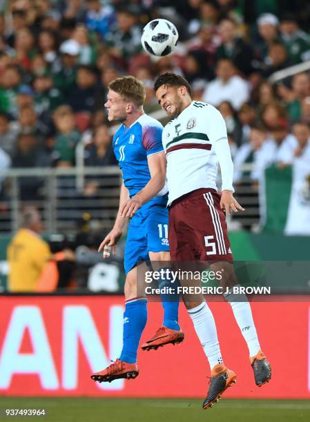 Bjorn Sigurdarson of Iceland vies for the header with Diego Reyes of Mexico on March 23, 2018 in Santa Clara, California, during their international...
