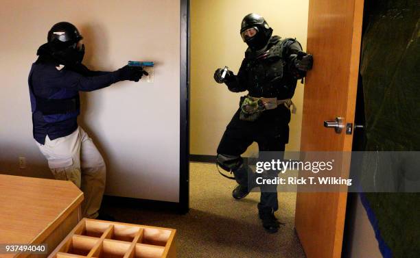 Student shoots a gunman with Simunition in a defensive scenario during a Tac*One Consulting "Lone Wolf" civilian active shooter response course for...