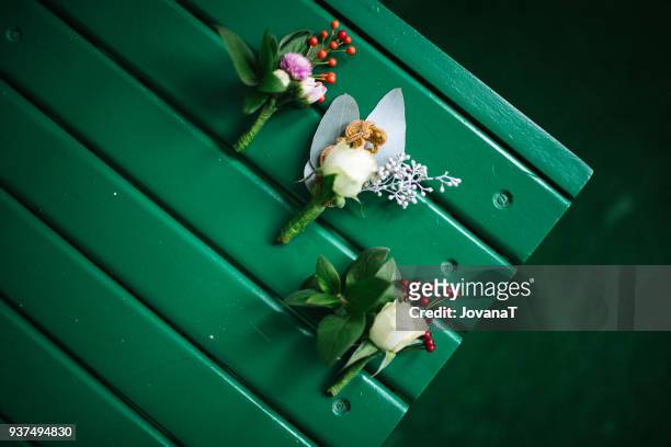 three wedding corsages on green chair - corsage imagens e fotografias de stock