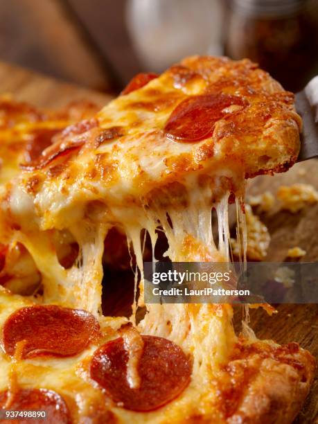 cheesy pepperoni pizza - pepperoni pizza stock pictures, royalty-free photos & images