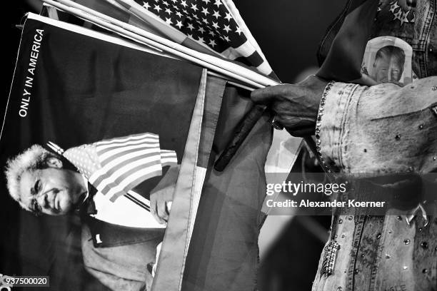 Don King holds several national flags next to a portrait of the President of the United States of America Donald Trump at the IBO Intercontinental...