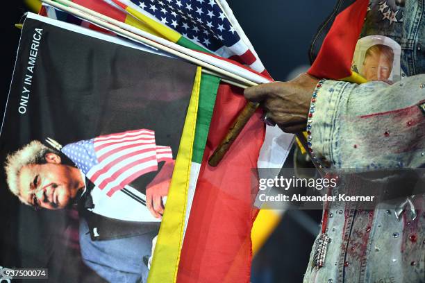 Don King holds several national flags next to a portrait of the President of the United States of America Donald Trump at the IBO Intercontinental...