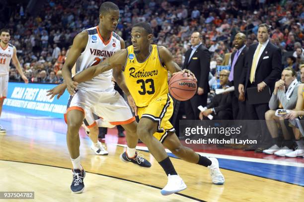 Arkel Lamar of the UMBC Retrievers dribbles by Nigel Johnson of the Virginia Cavaliers during the first round of the 2018 NCAA Men's Basketball...