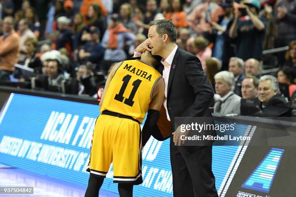 Head coach Ryan Odom hugs K.J. Maura of the UMBC Retrievers during the first round of the 2018 NCAA Men's Basketball Tournament against the Virginia...