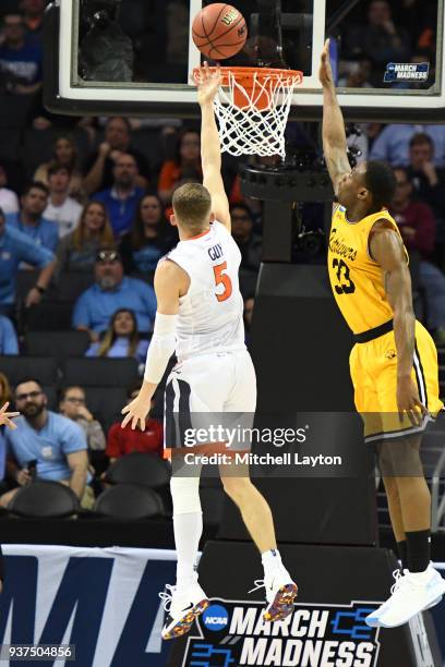 Kyle Guy of the Virginia Cavaliers drives to the basket by Arkel Lamar of the UMBC Retrievers during the first round of the 2018 NCAA Men's...