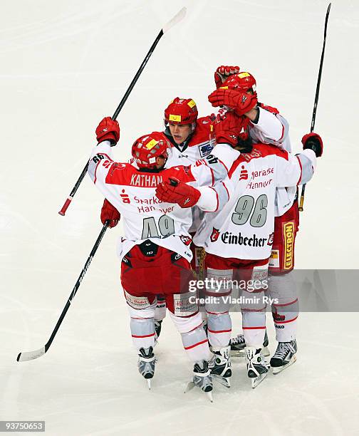 Rainer Koettstorfer of Scorpions is celebrated by his team mates after scoring his team's first goal during the Deutsche Eishockey Liga game between...
