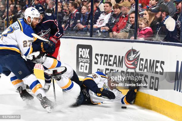 Colton Parayko of the St. Louis Blues falls to the ice while battling for a loose puck with Alex Pietrangelo of the St. Louis Blues and Thomas Vanek...