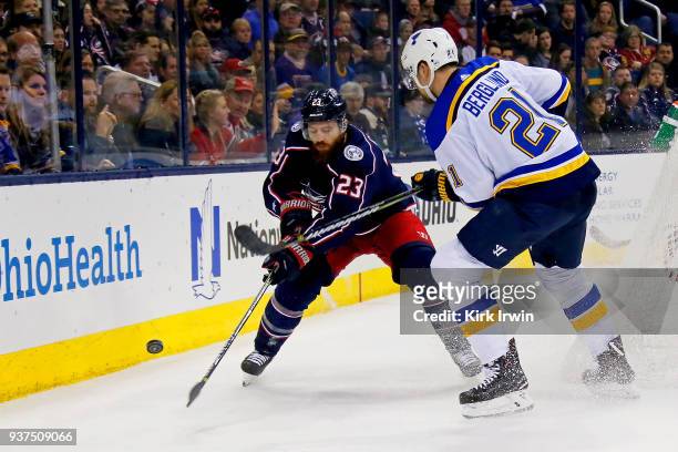 Ian Cole of the Columbus Blue Jackets and Patrik Berglund of the St. Louis Blues battle for control of the puck during the first period on March 24,...