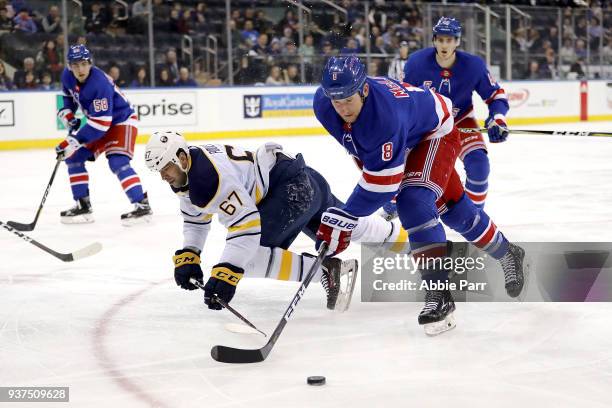 Cody McLeod of the New York Rangers reaches for the puck against Benoit Pouliot of the Buffalo Sabres in the first period during their game at...