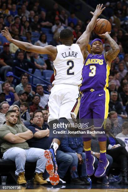 Isaiah Thomas of the Los Angeles Lakers shoots over Ian Clark of the New Orleans Pelicans during the first half at the Smoothie King Center on March...