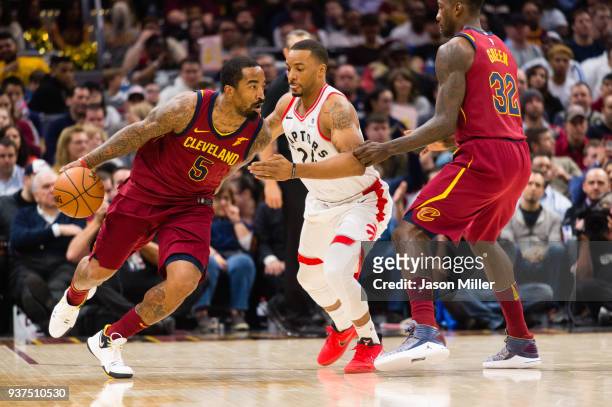 Norman Powell of the Toronto Raptors guards JR Smith as Jeff Green of the Cleveland Cavaliers sets a pic during the first half at Quicken Loans Arena...