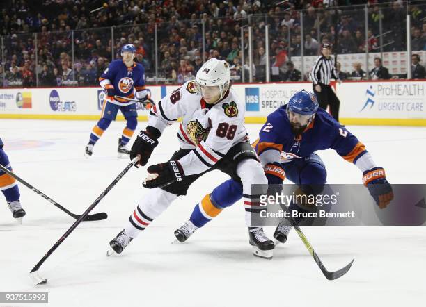 Patrick Kane of the Chicago Blackhawks carries the puck past Nick Leddy of the New York Islanders during the first period at the Barclays Center on...
