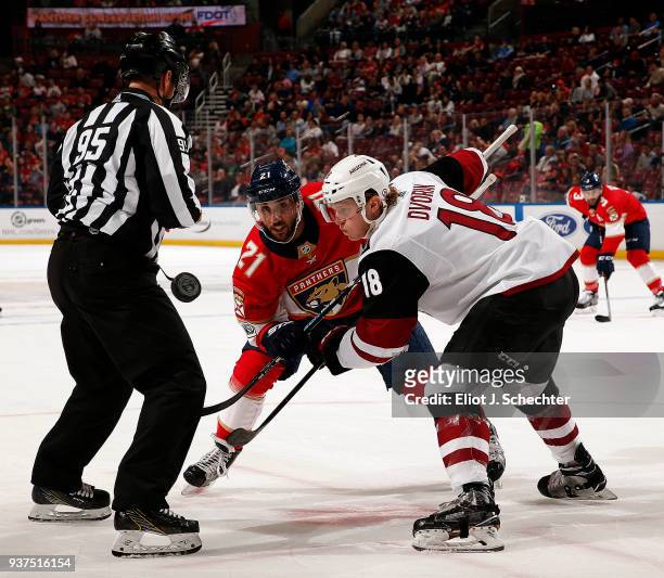 Christian Dvorak of the Arizona Coyotes faces off against Vincent Trocheck of the Florida Panthers at the BB&T Center on March 24, 2018 in Sunrise,...