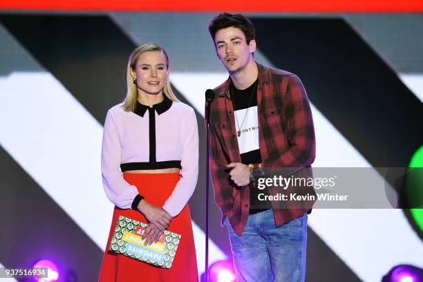 Kristen Bell and Grant Gustin speak onstage at Nickelodeon's 2018 Kids' Choice Awards at The Forum on March 24, 2018 in Inglewood, California.