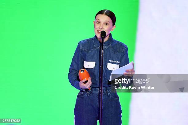 Millie Bobby Brown accepts the Favorite TV Actress award for 'Stranger Things' onstage at Nickelodeon's 2018 Kids' Choice Awards at The Forum on...