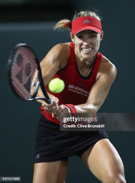 Angelique Kerber of Germany plays a backhand against Anastasia Pavlyuchenkova of Russia in their third round match during the Miami Open Presented by...