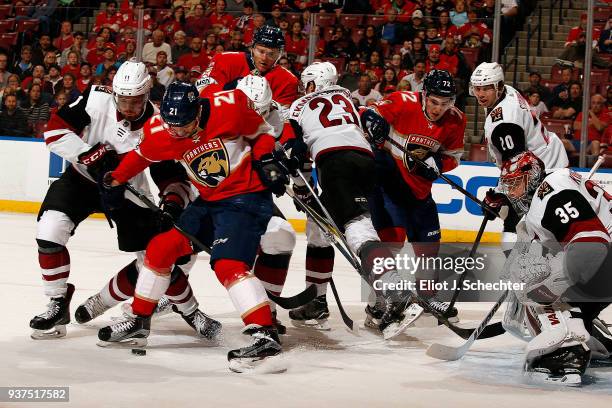 Vincent Trocheck of the Florida Panthers tangles with Brendan Perlini of the Arizona Coyotes at the BB&T Center on March 24, 2018 in Sunrise, Florida.